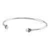 An open silver bangle capped with semi precious stones promoting serenity