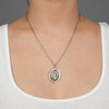 A close up of a model wearing Pyrrha's sterling silver Festive Spirit talisman.