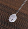 A close up of our sterling silver Love Her but Leave Her Wild talisman on a silver chain.