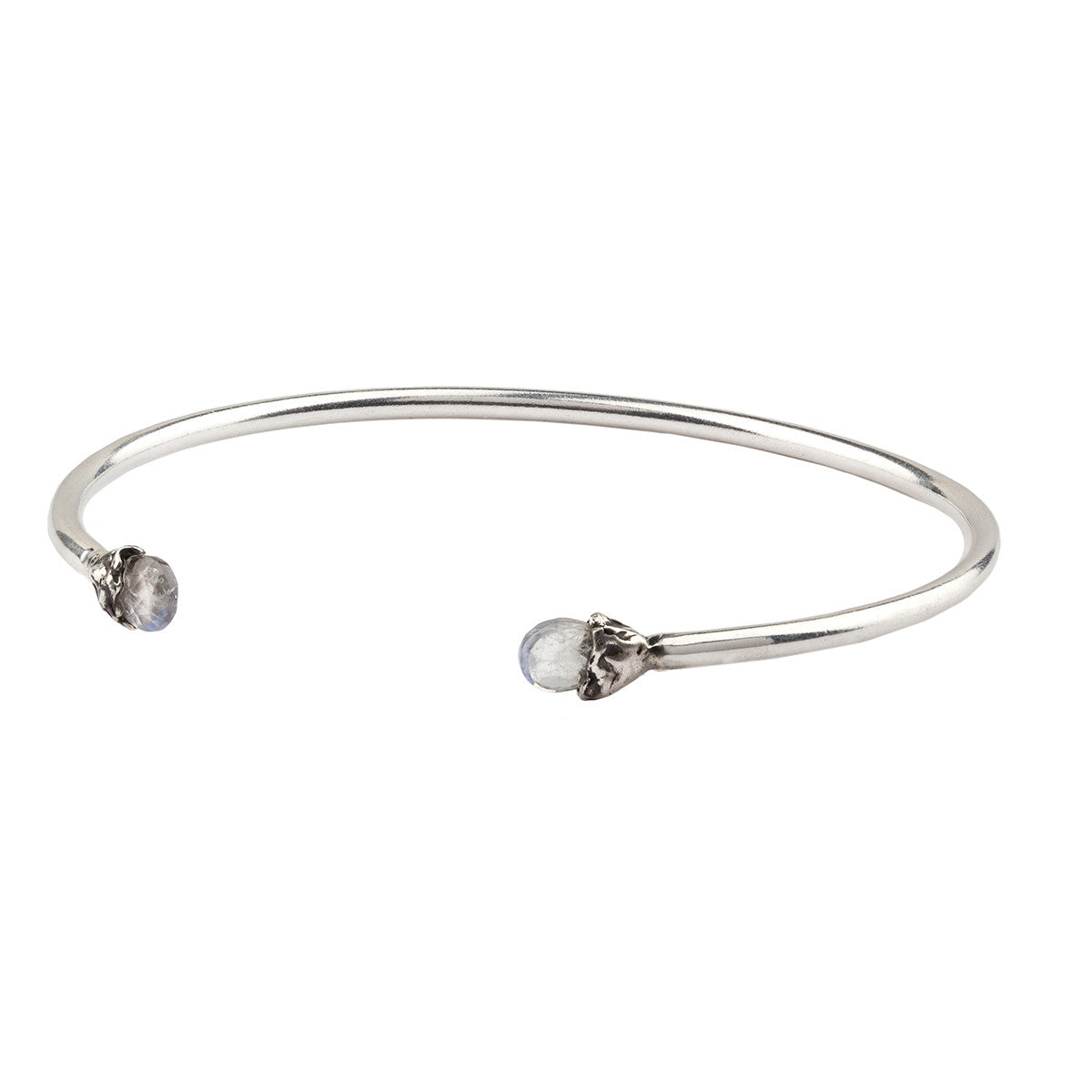 An open silver bangle capped with semi precious stones promoting improvement