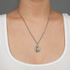 A close up of a model wearing Pyrrha's sterling silver Integrity Talisman Necklace.