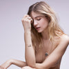 A model wearing our Ab Hinc (From Here On) Narrow 14K Gold Textured Band Ring