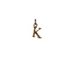 A bronze "K" charm.