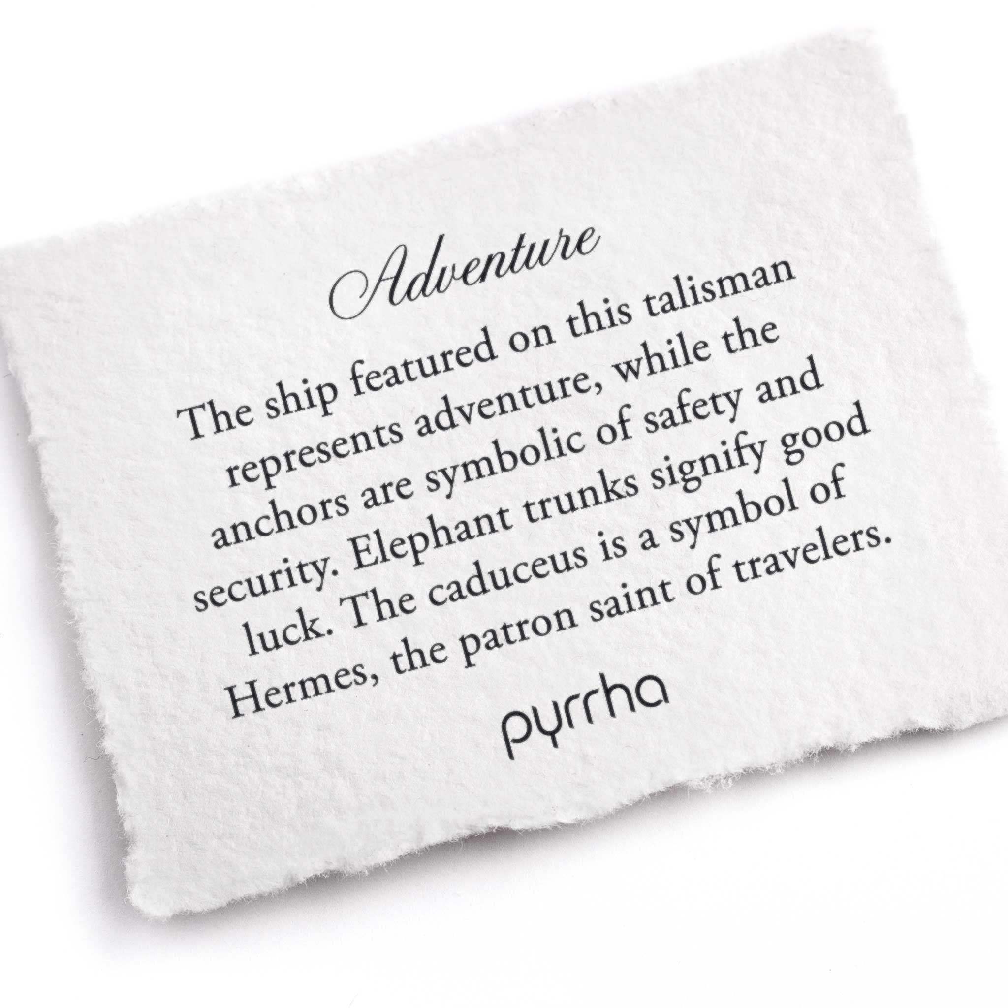 A hand-torn, letterpress printed card describing the meaning for Pyrrha's Adventure Talisman