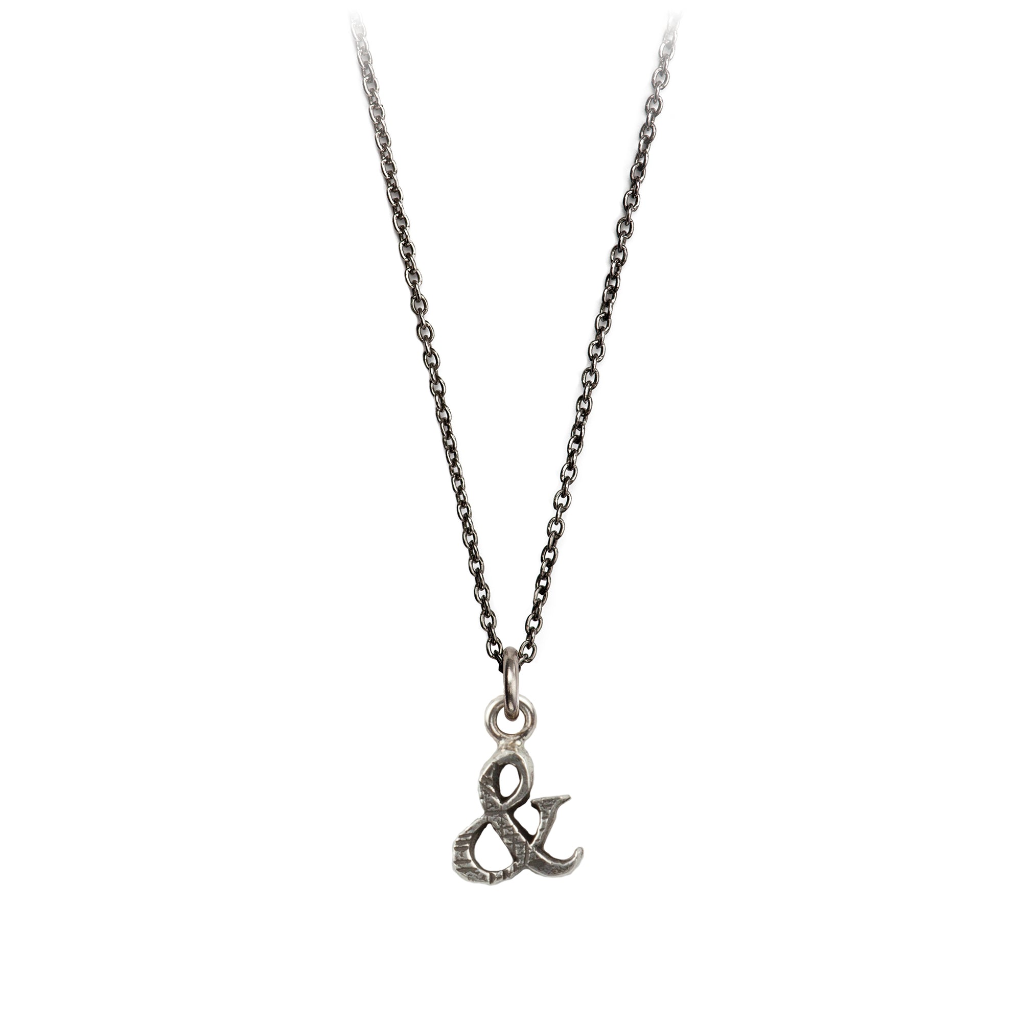 A sterling silver Ampersand charm on a silver chain.