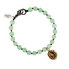A green beaded bracelet featuring our bronze Tireless talisman.