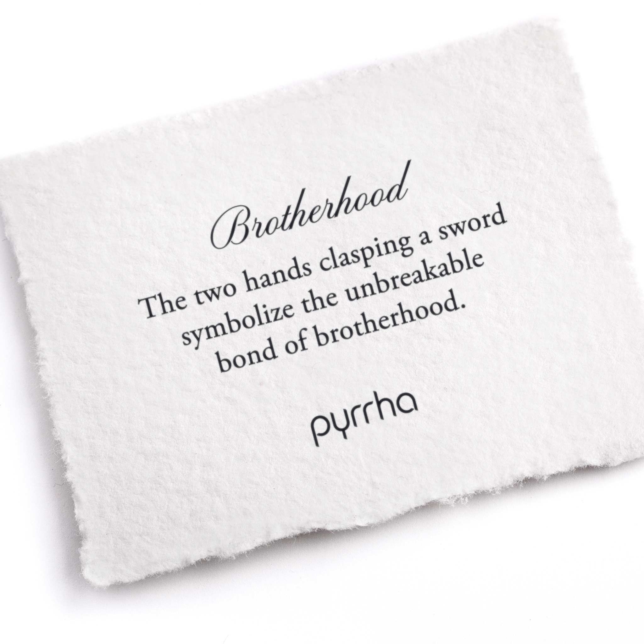 A hand-torn, letterpress printed card describing the meaning for Pyrrha's Brotherhood Talisman