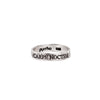 A silver band ring with the phrase Carpe Noctem engraved into it