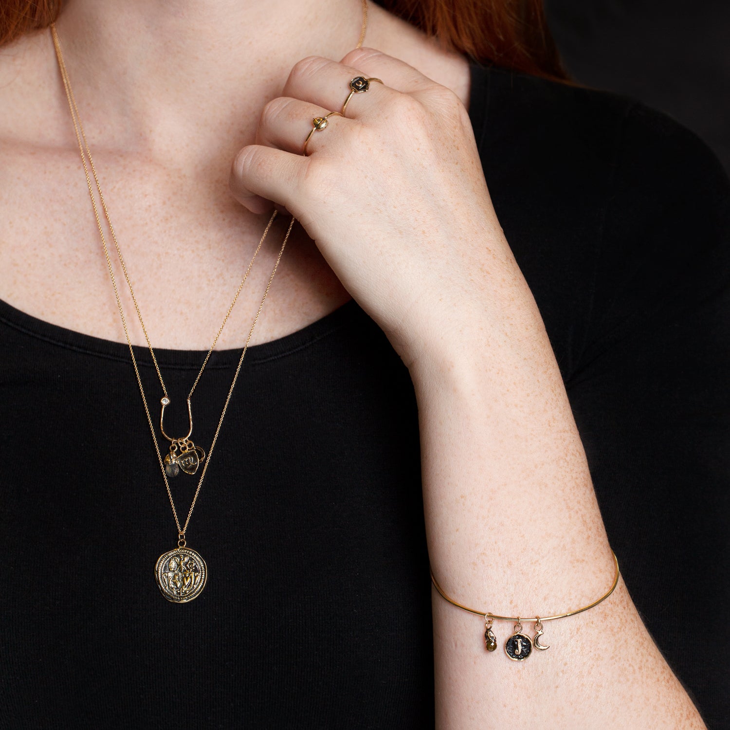 A close up of a model wearing our Acorn 14K Gold Symbol Ring.