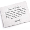 A hand-torn, letterpress printed card describing the meaning for Pyrrha's Conscious Creation Signature Talisman Necklace