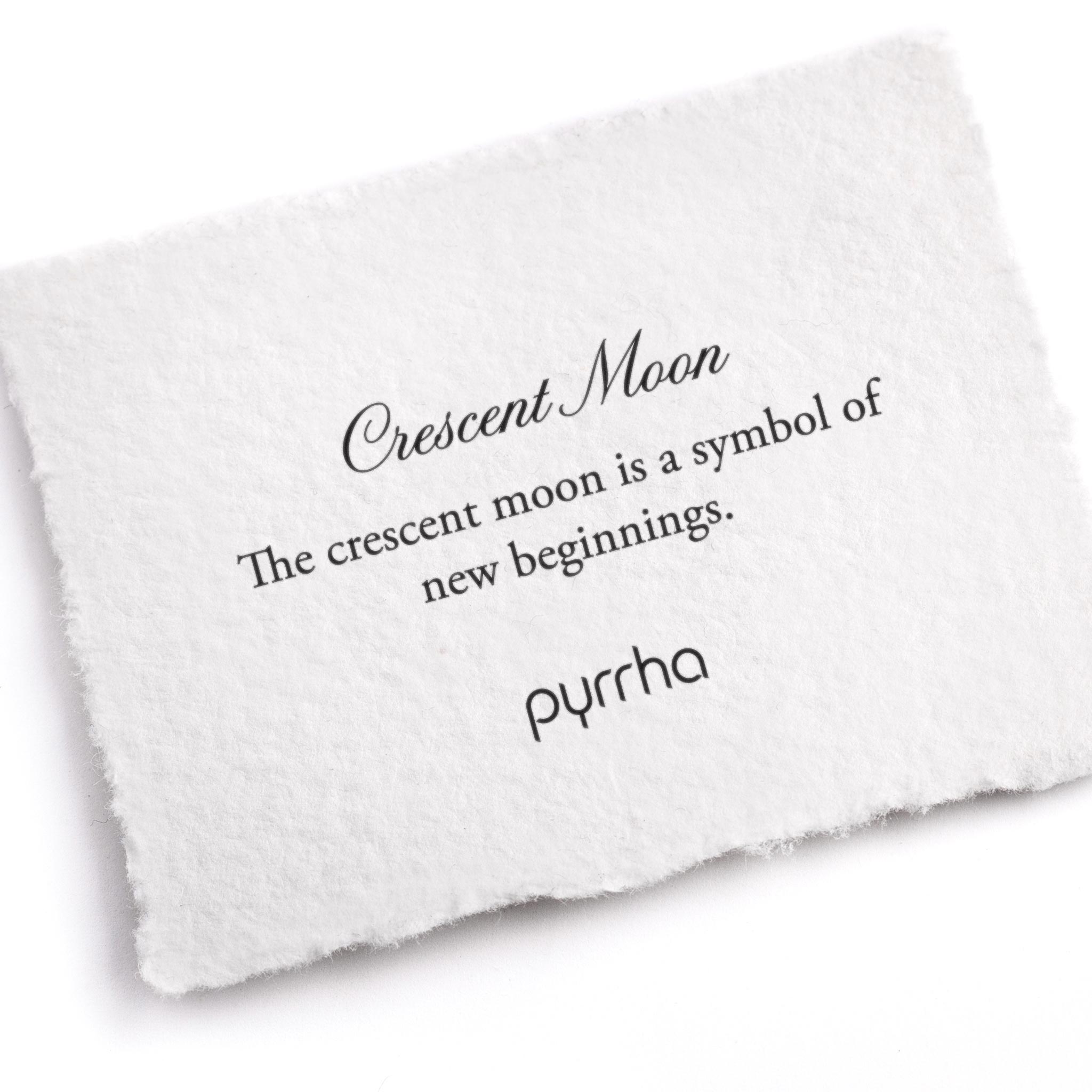 A handtorn cotton card describing the meaning for our Crescent Moon 14K Gold Symbol Charm Bracelet.