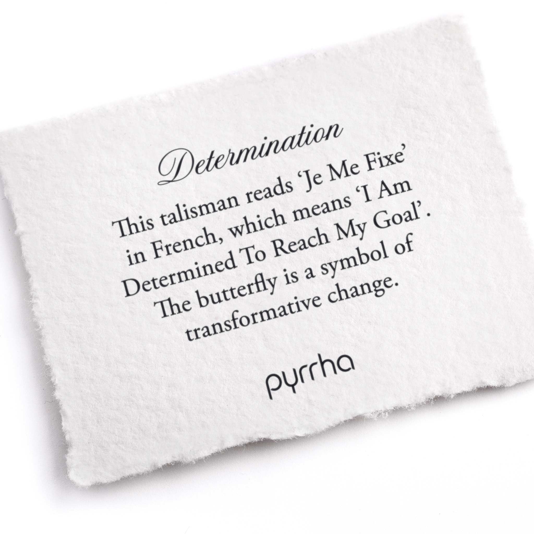 A hand-torn, letterpress printed card describing the meaning for Pyrrha's Determination Talisman