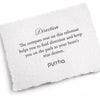 A hand-torn, letterpress printed card describing the meaning for Pyrrha's Direction Wide Braided Bracelet