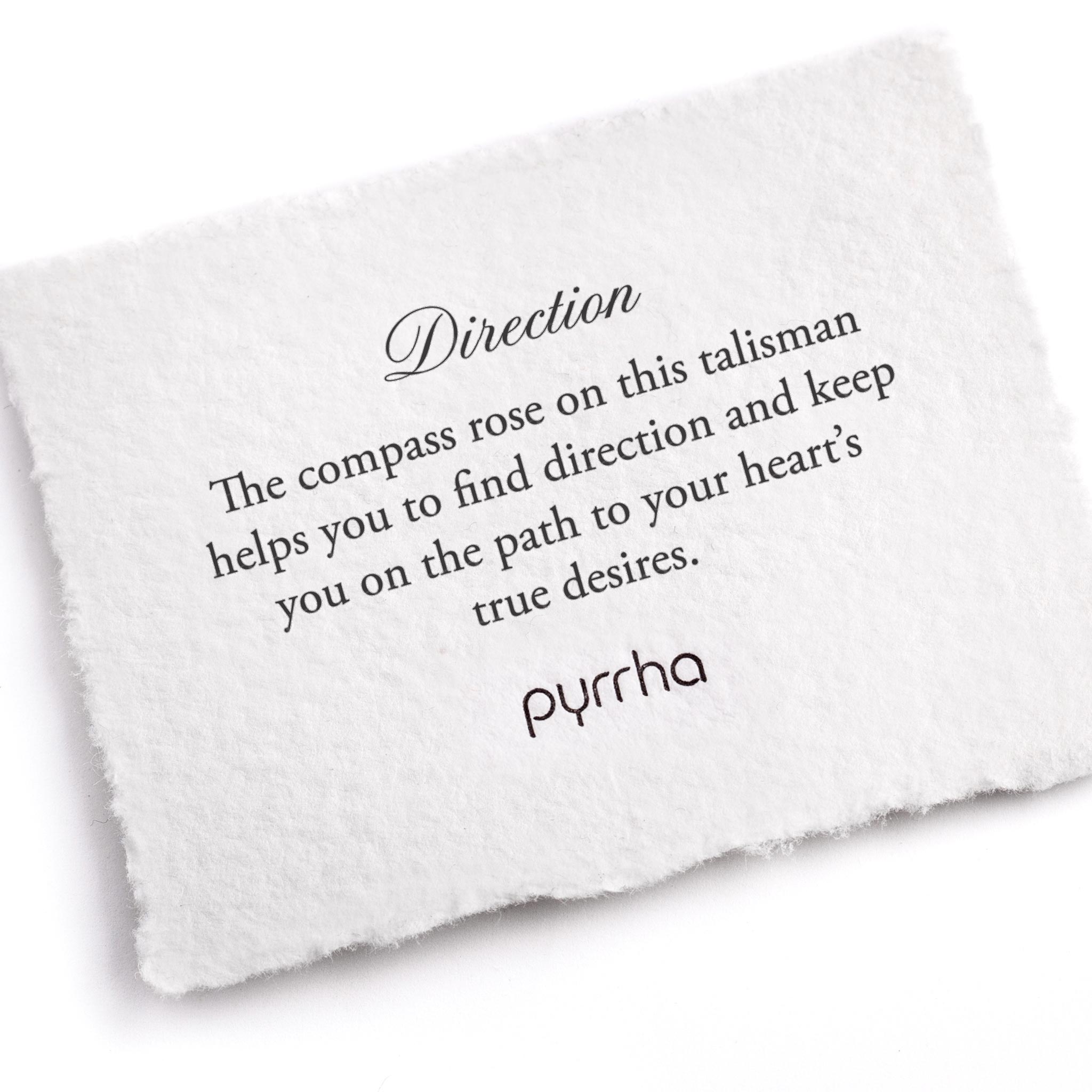 A hand-torn, letterpress printed card describing the meaning for Pyrrha's Direction Talisman Necklace