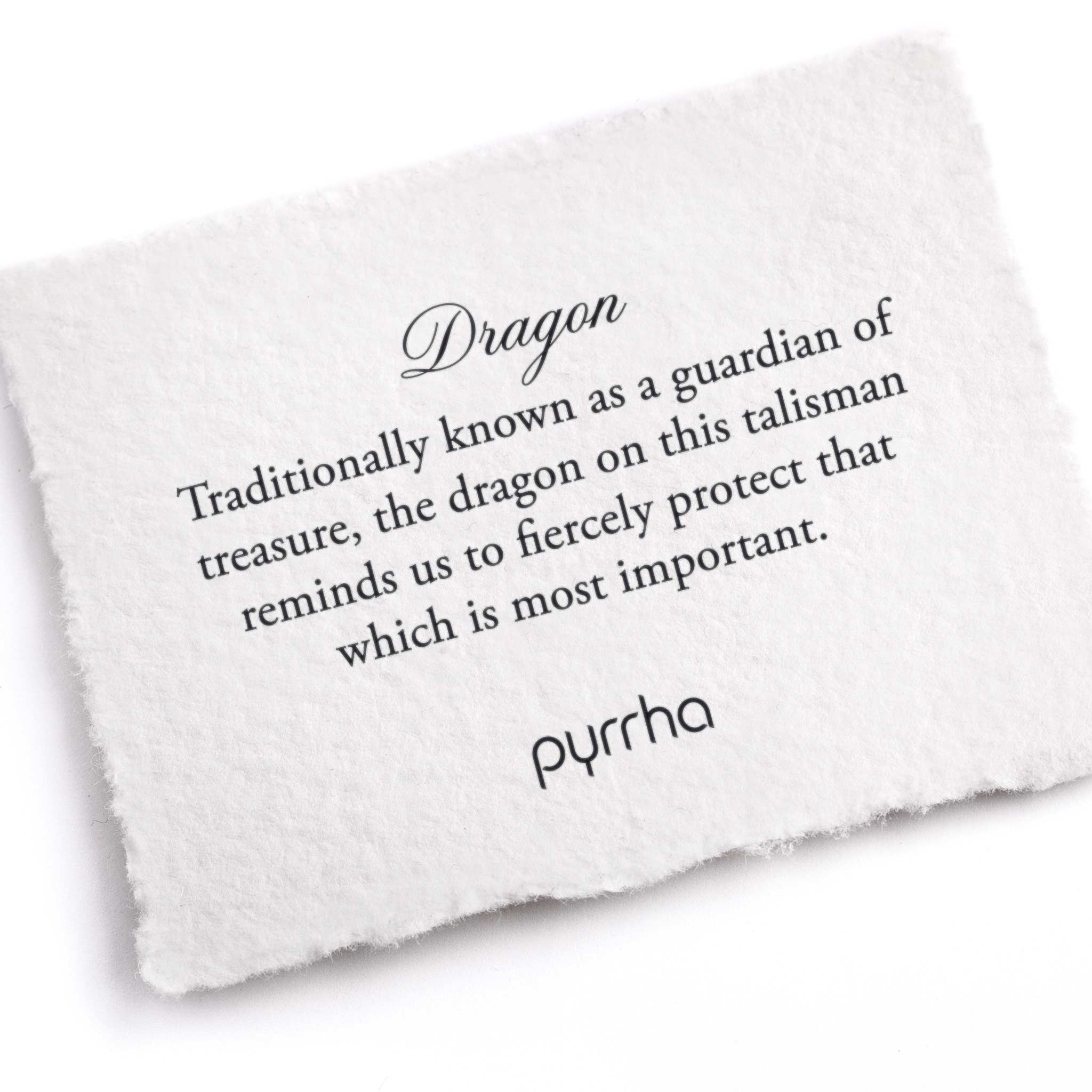 A hand-torn, letterpress printed card describing the meaning for Pyrrha's Dragon Talisman