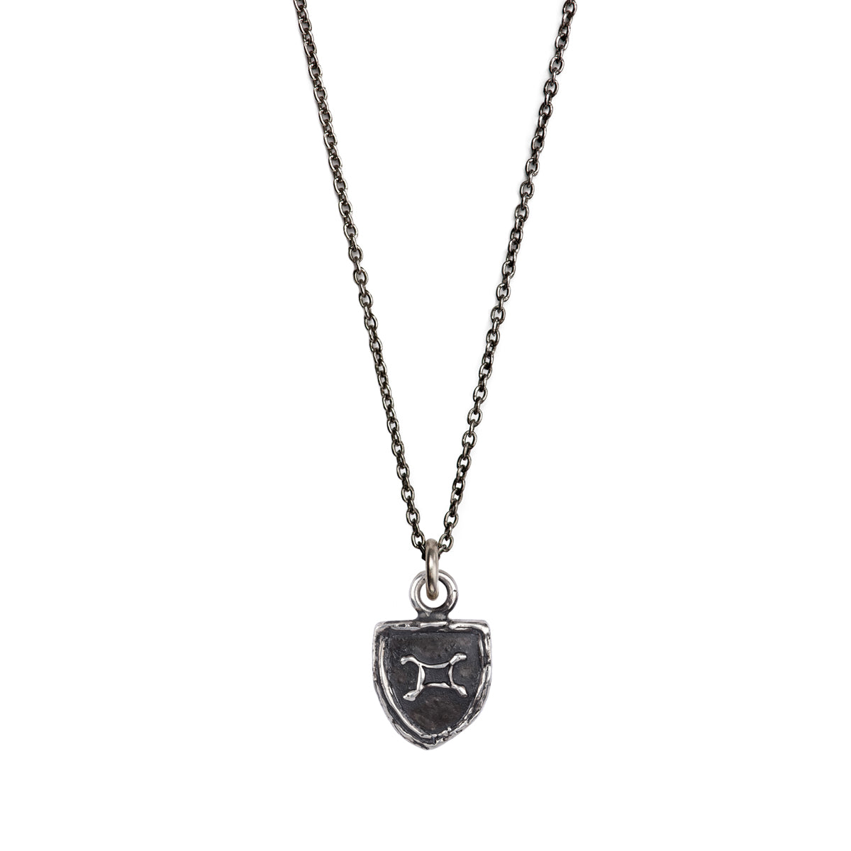 A sterling silver Gemini zodiac charm on a silver chain.