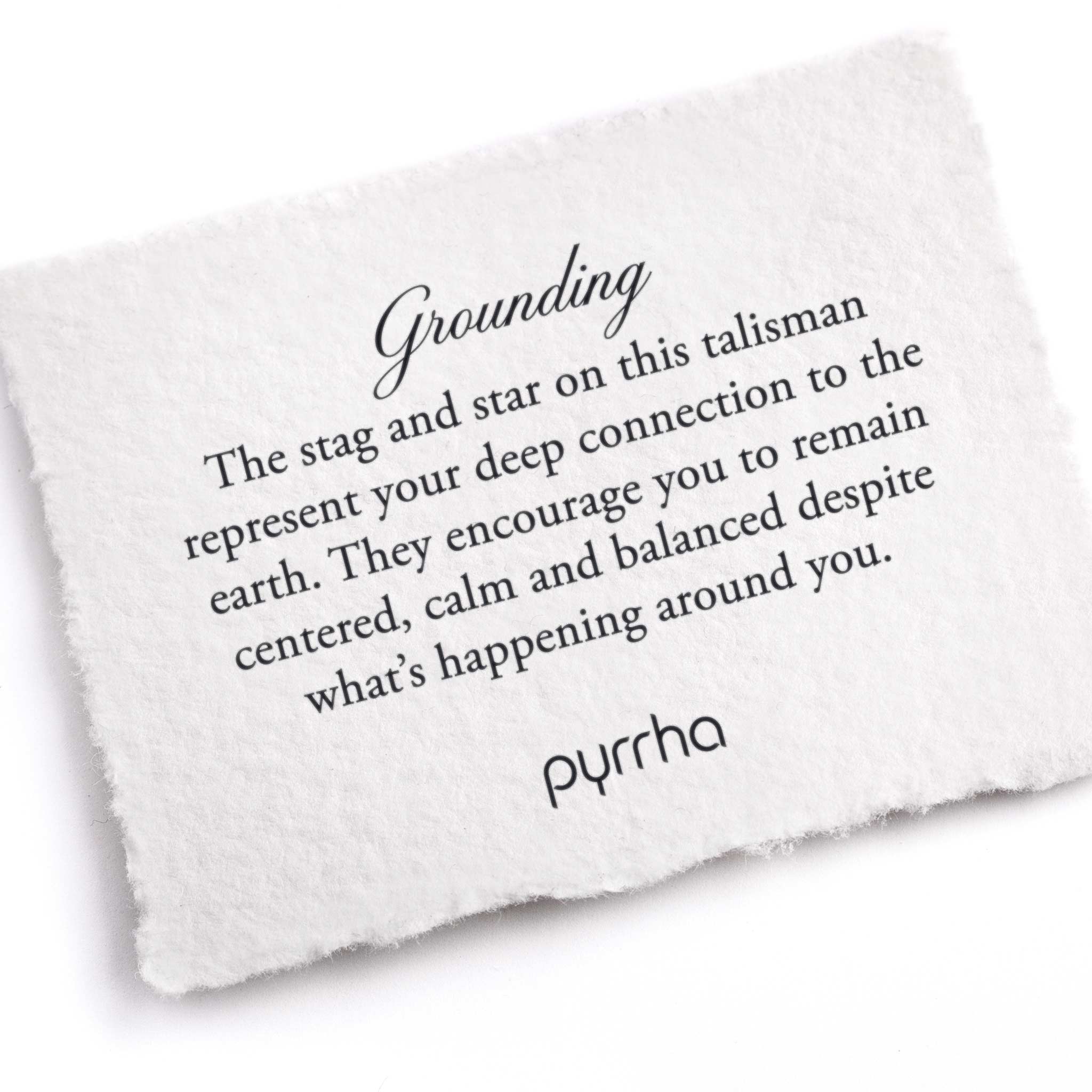 A hand-torn, letterpress printed card describing the meaning for Pyrrha's Grounding Talisman Necklace