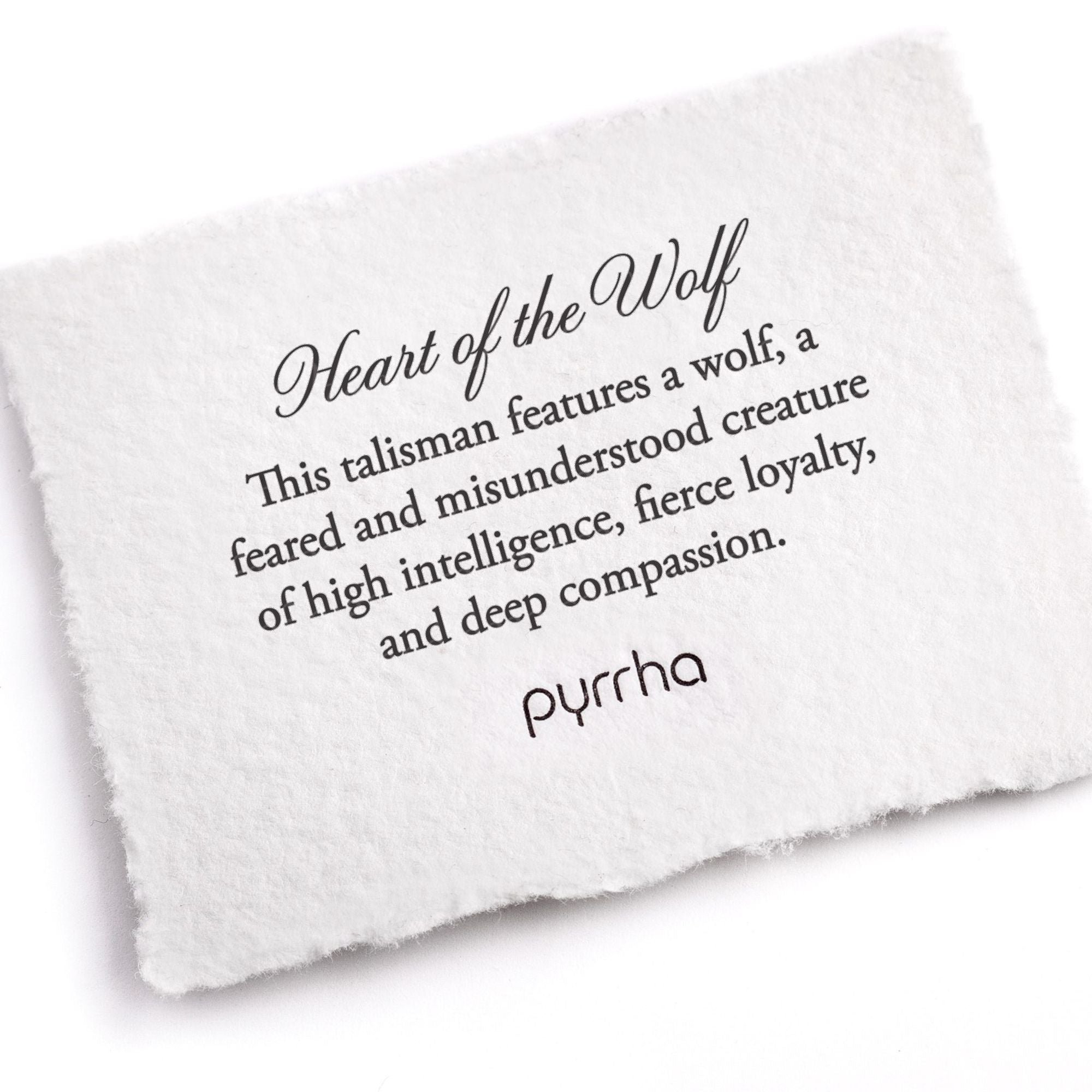 A hand-torn, letterpress printed card describing the meaning for Pyrrha's Heart of the Wolf Talisman Necklace