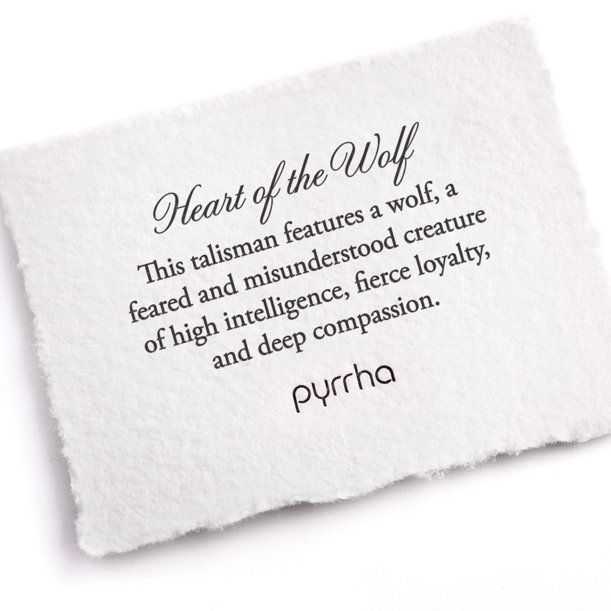 A handtorn cotton card describing the meaning for our Heart of the Wolf Tie Bar.