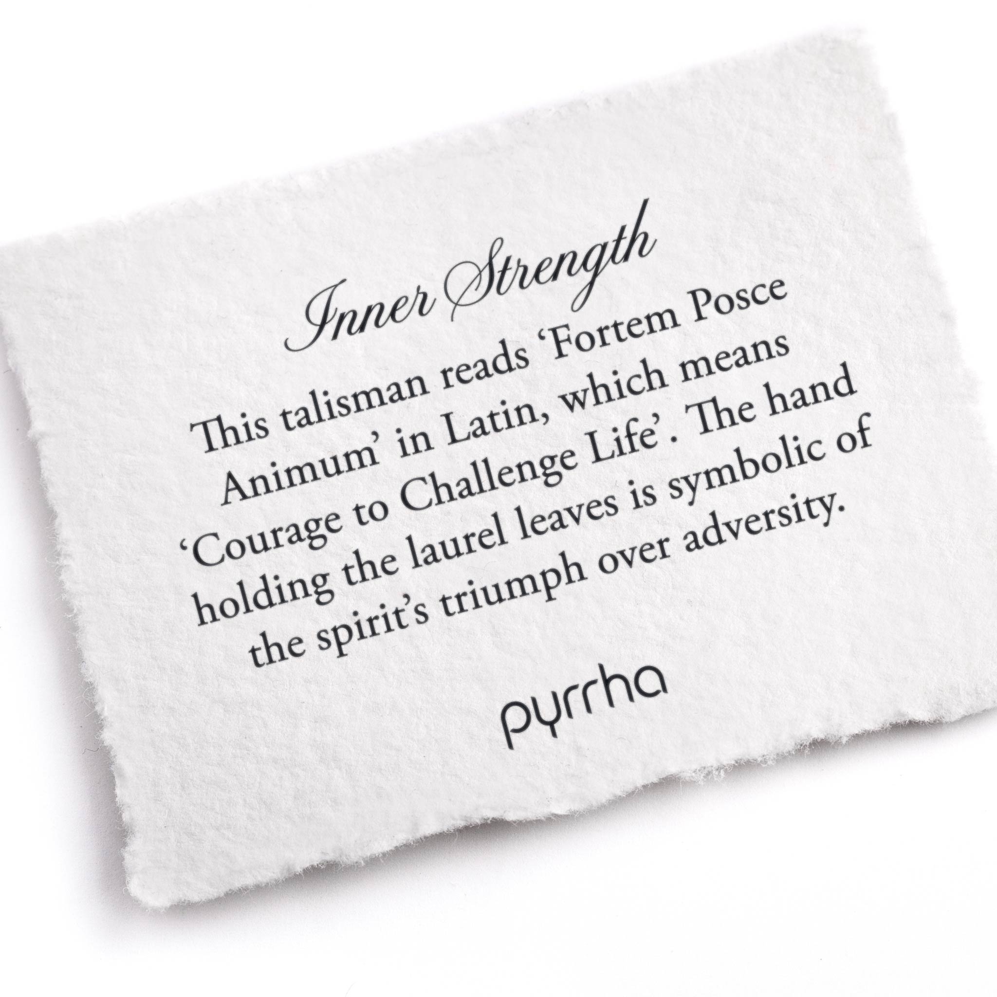 A hand-torn, letterpress printed card describing the meaning for Pyrrha's Inner Strength Talisman Necklace