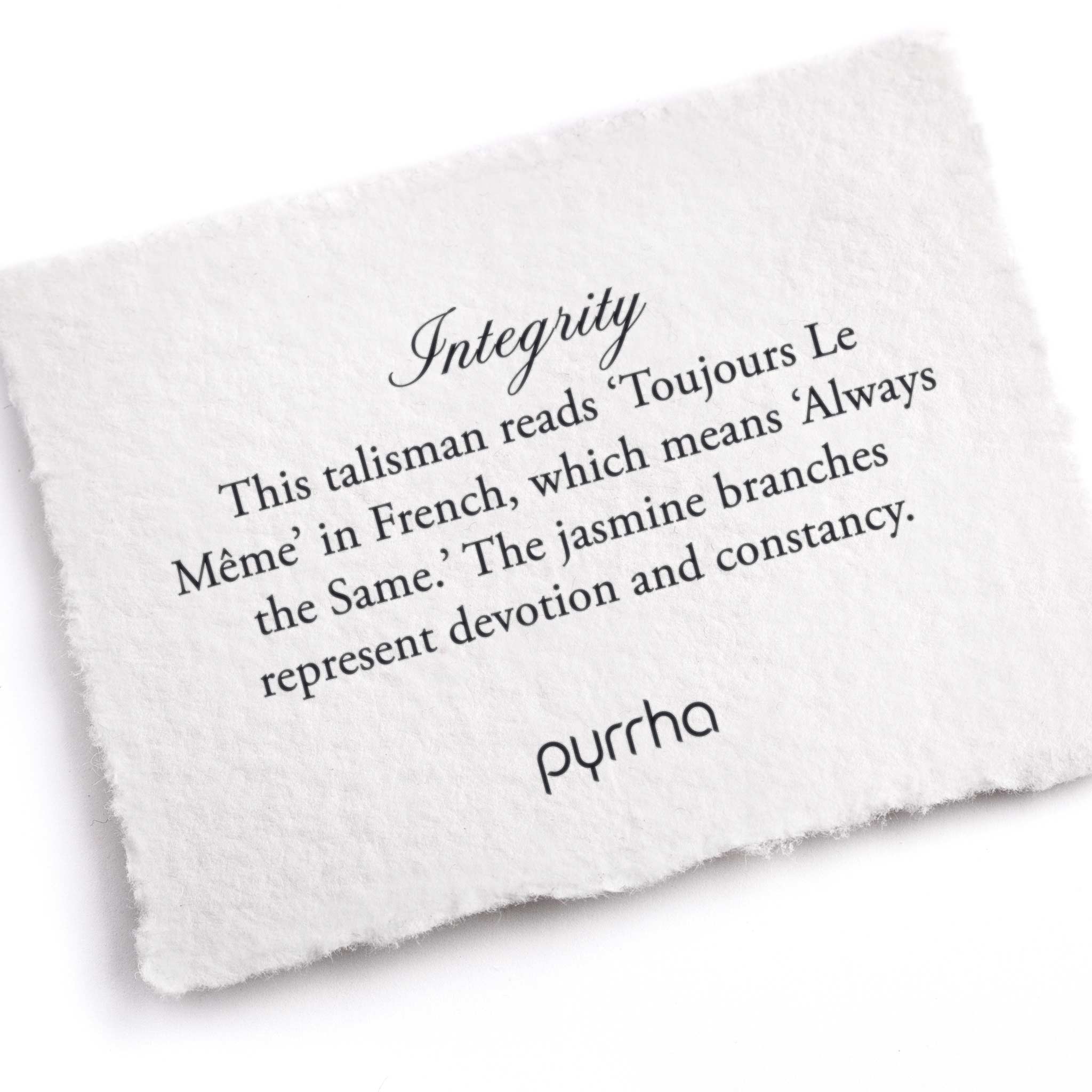 A hand-torn, letterpress printed card describing the meaning for Pyrrha's Integrity Talisman 