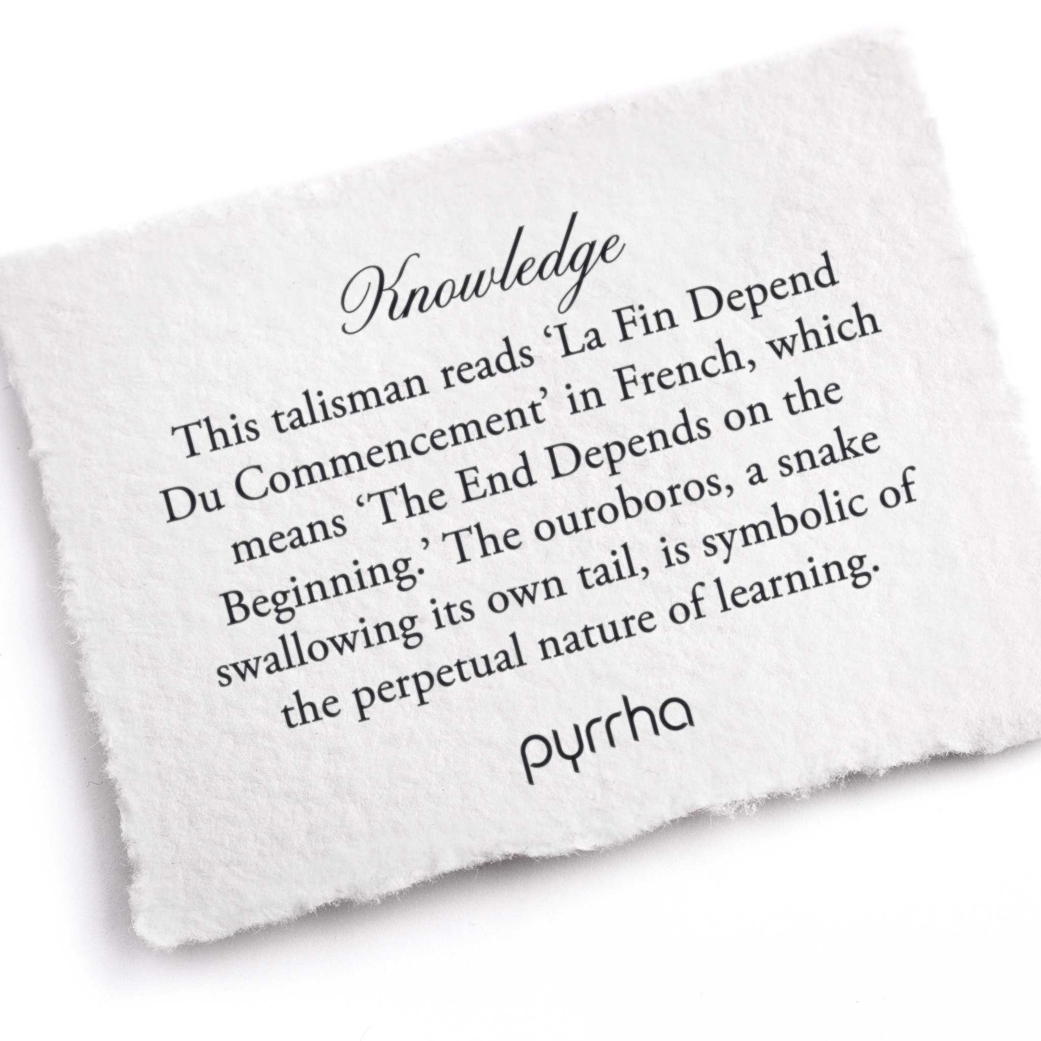 A hand-torn, letterpress printed card describing the meaning for Pyrrha's Knowledge Talisman 