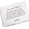 A hand-torn, letterpress printed card describing the meaning for Pyrrha's Live in the Moment Talisman Necklace
