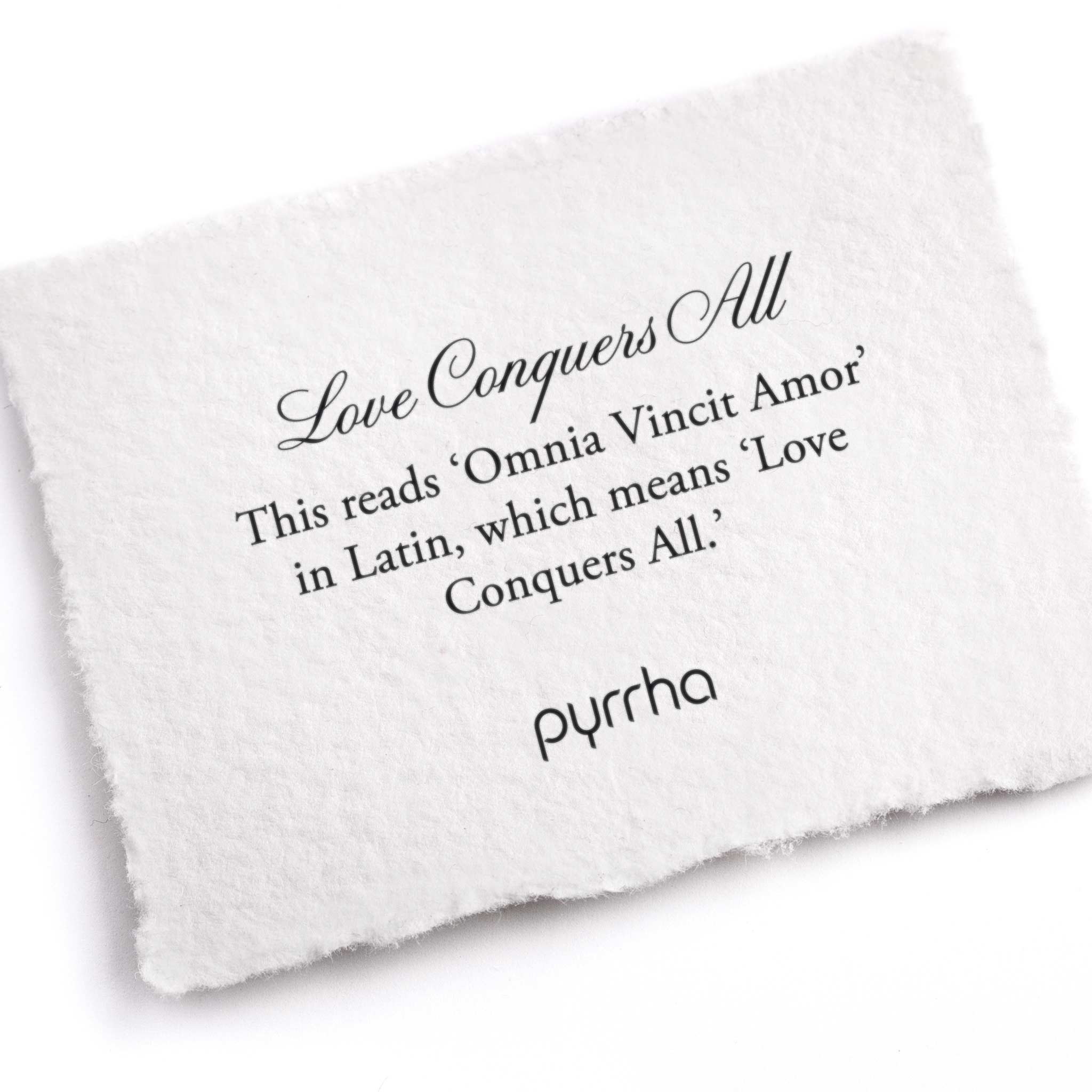 A hand-torn, letterpress printed card describing the meaning for Pyrrha's Love Conquers All Talisman 