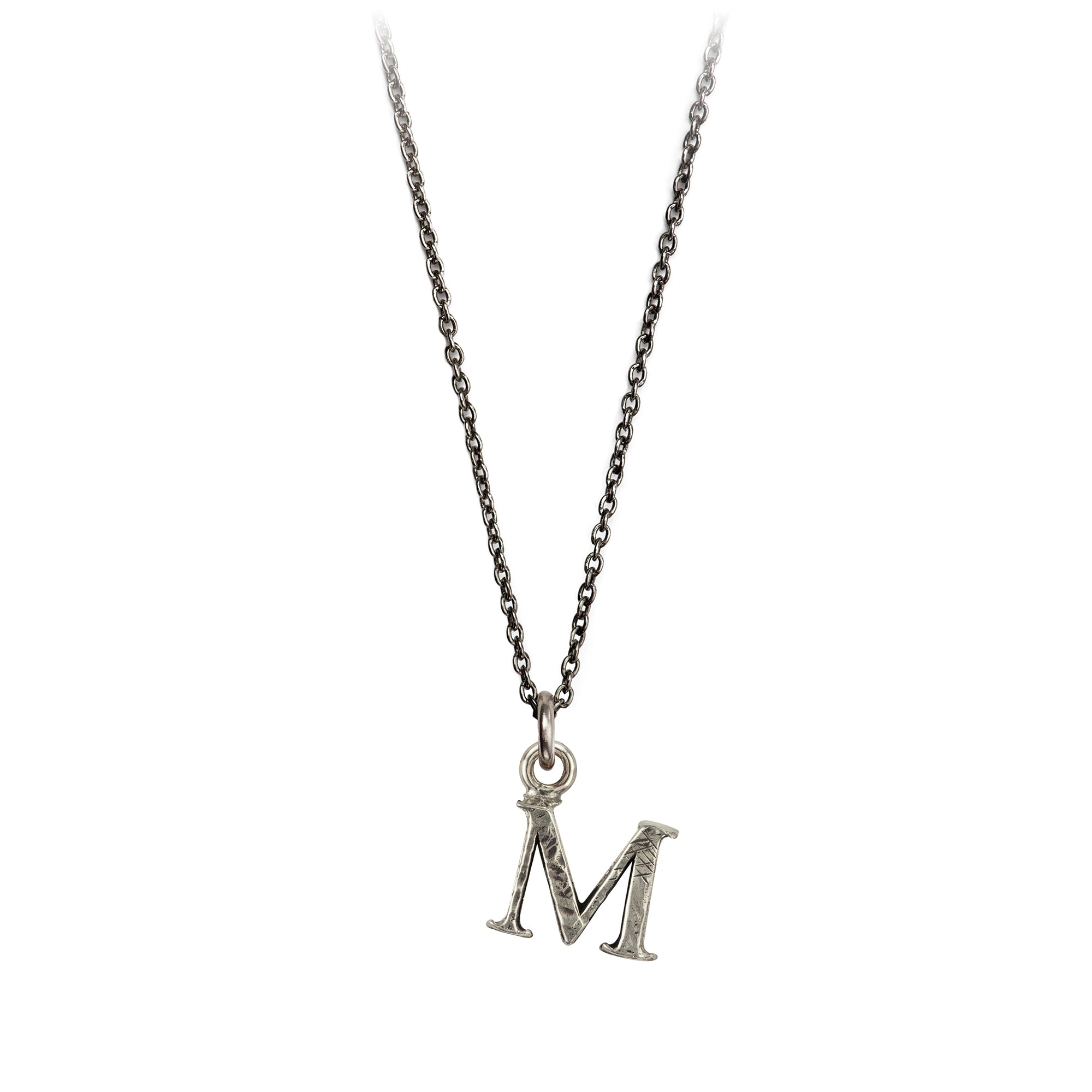A sterling silver letter "M" charm on a silver chain.