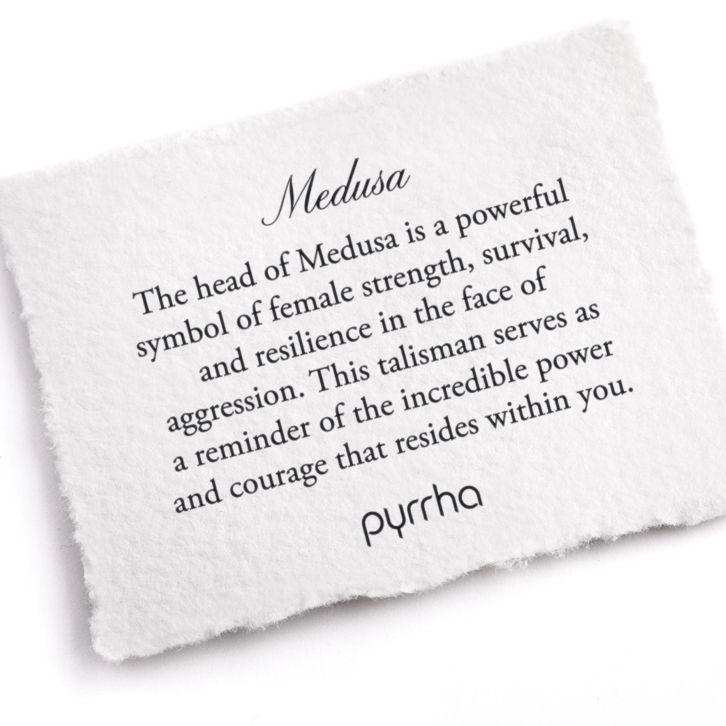 A hand-torn, letterpress printed card describing the meaning for Pyrrha's Medusa Talisman