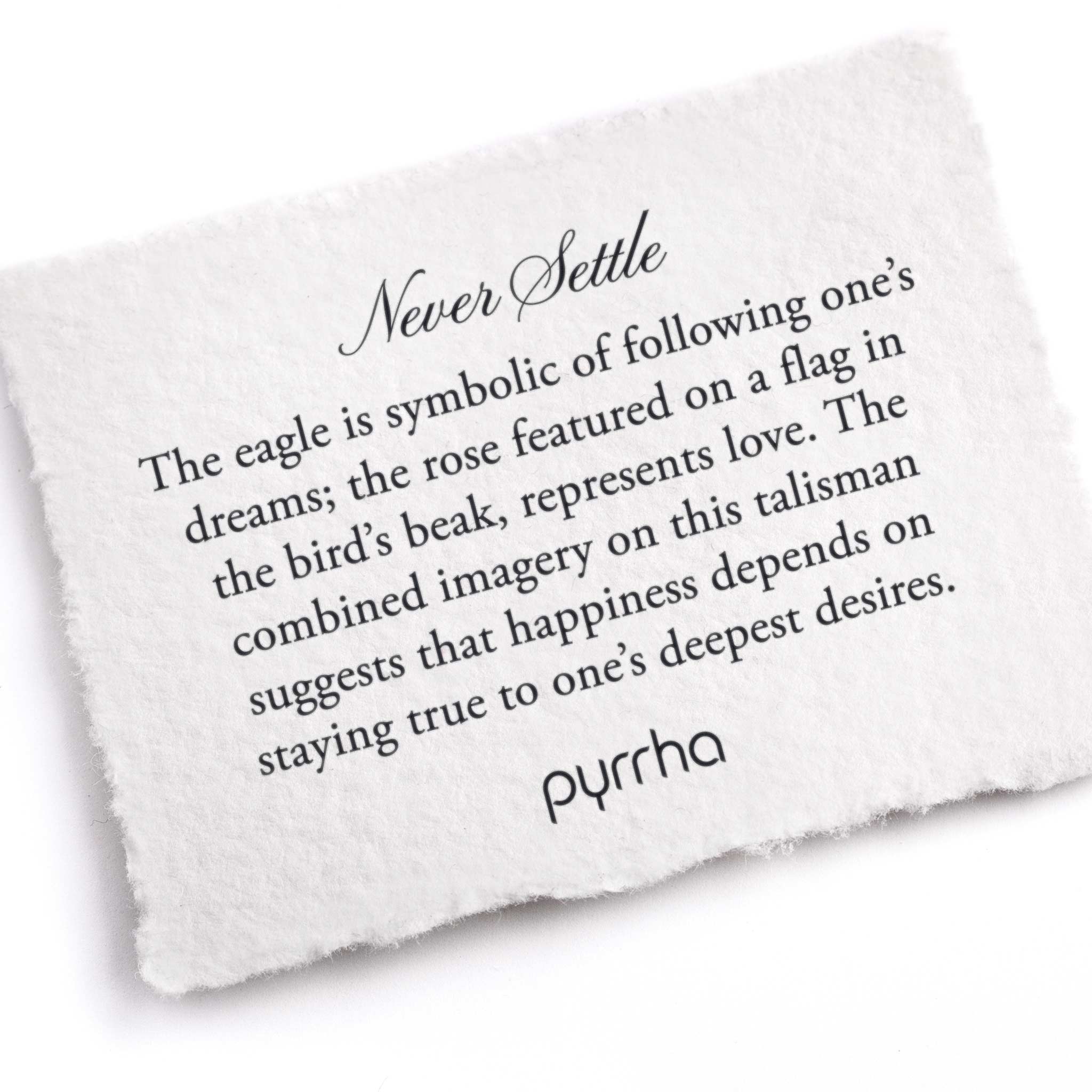 A hand-torn, letterpress printed card describing the meaning for Pyrrha's Never Settle Talisman