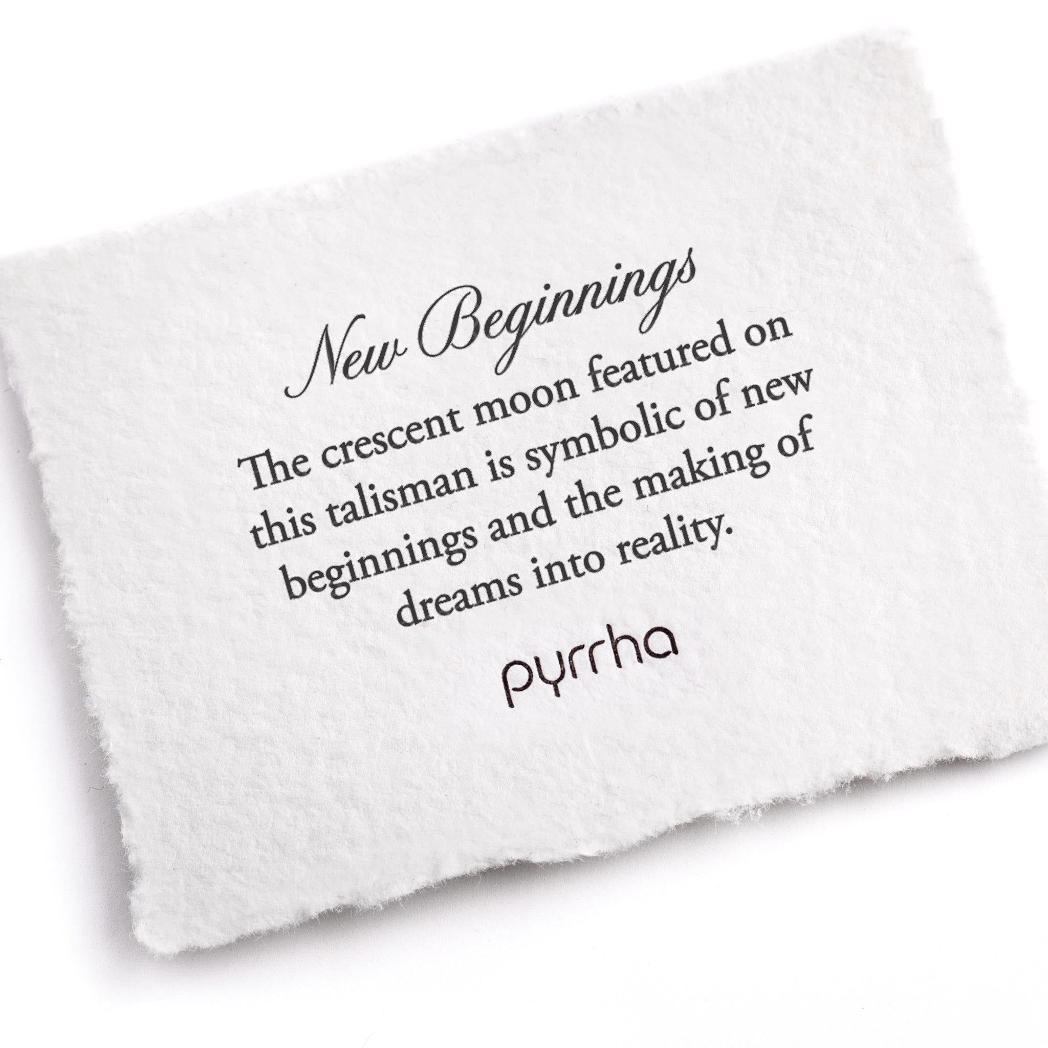 A hand-torn, letterpress printed card describing the meaning for Pyrrha's New Beginnings Talisman Necklace