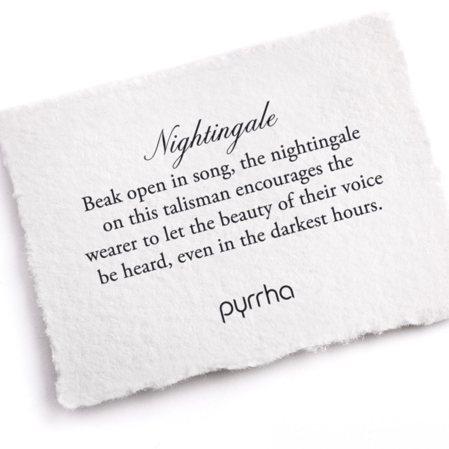 A hand-torn, letterpress printed card describing the meaning for Pyrrha's Nightingale Talisman