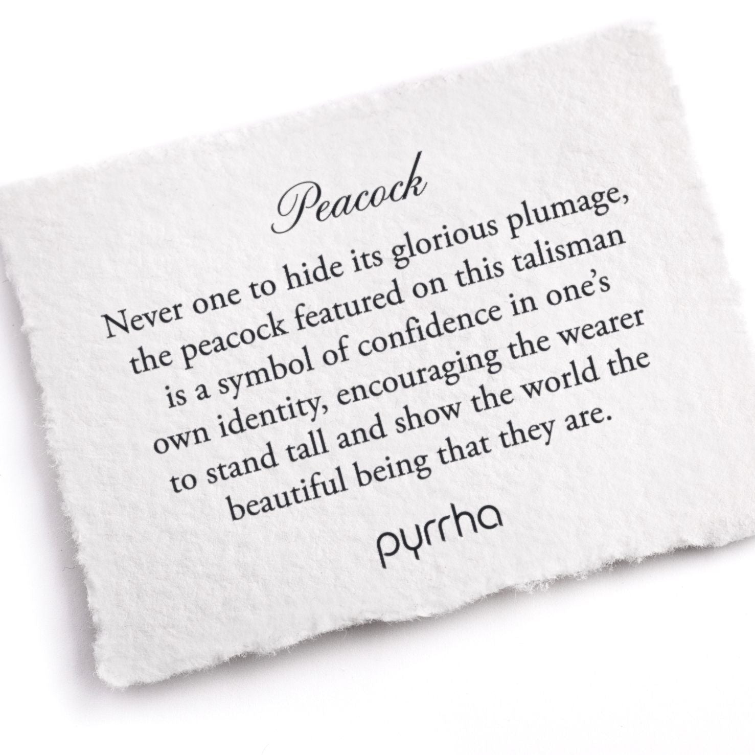 A hand-torn, letterpress printed card describing the meaning for Pyrrha's Peacock Talisman