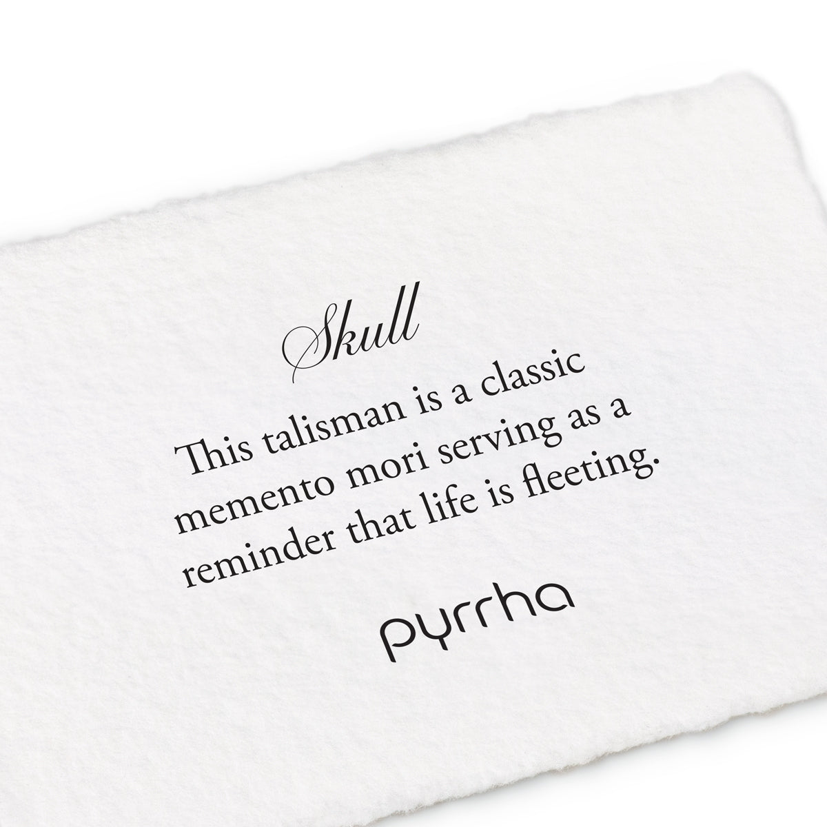 A handtorn cotton card describing the meaning for our Skull Symbol 14K Gold Charm Ring