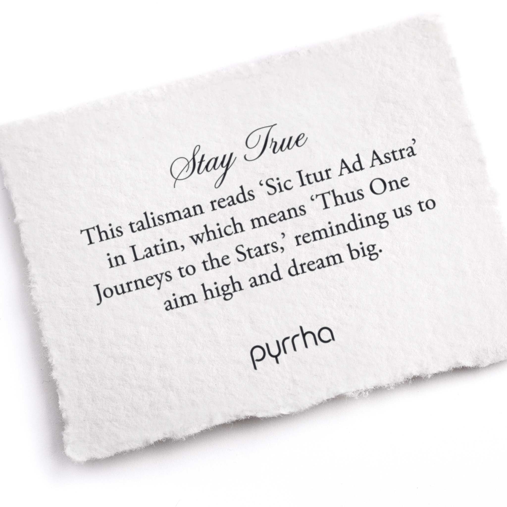 A hand-torn, letterpress printed card describing the meaning for Pyrrha's Stay True 14K Gold Talisman