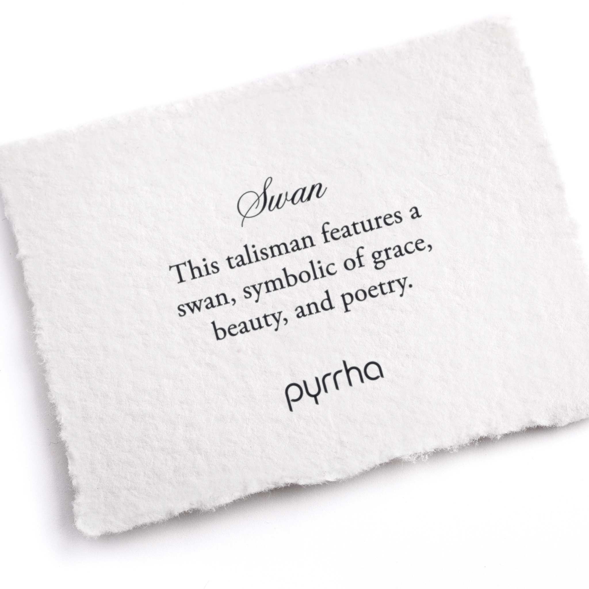 A hand-torn, letterpress printed card describing the meaning for Pyrrha's Swan Talisman 