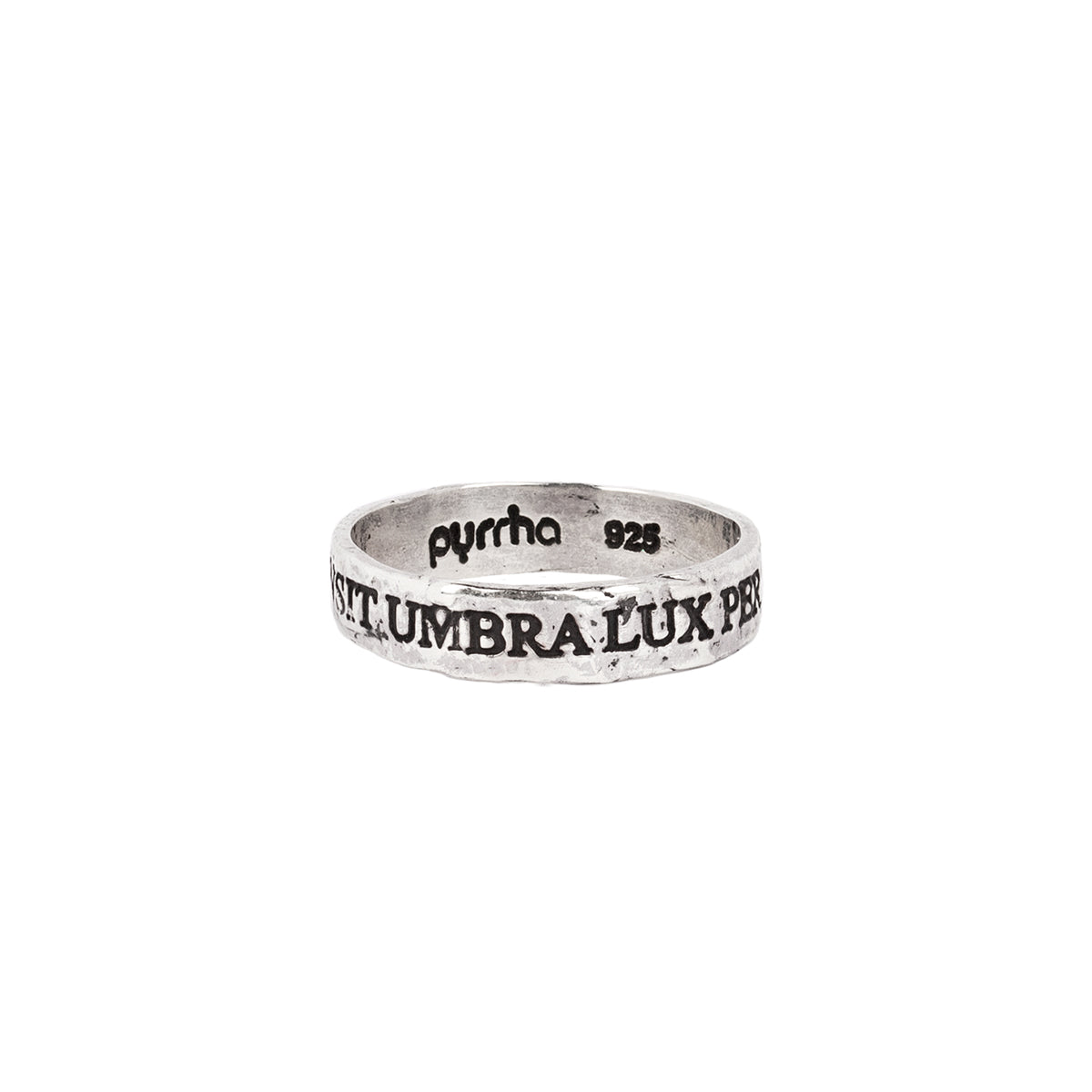 A silver band ring with the phrase Transit Umbra Lux Permanet engraved into it