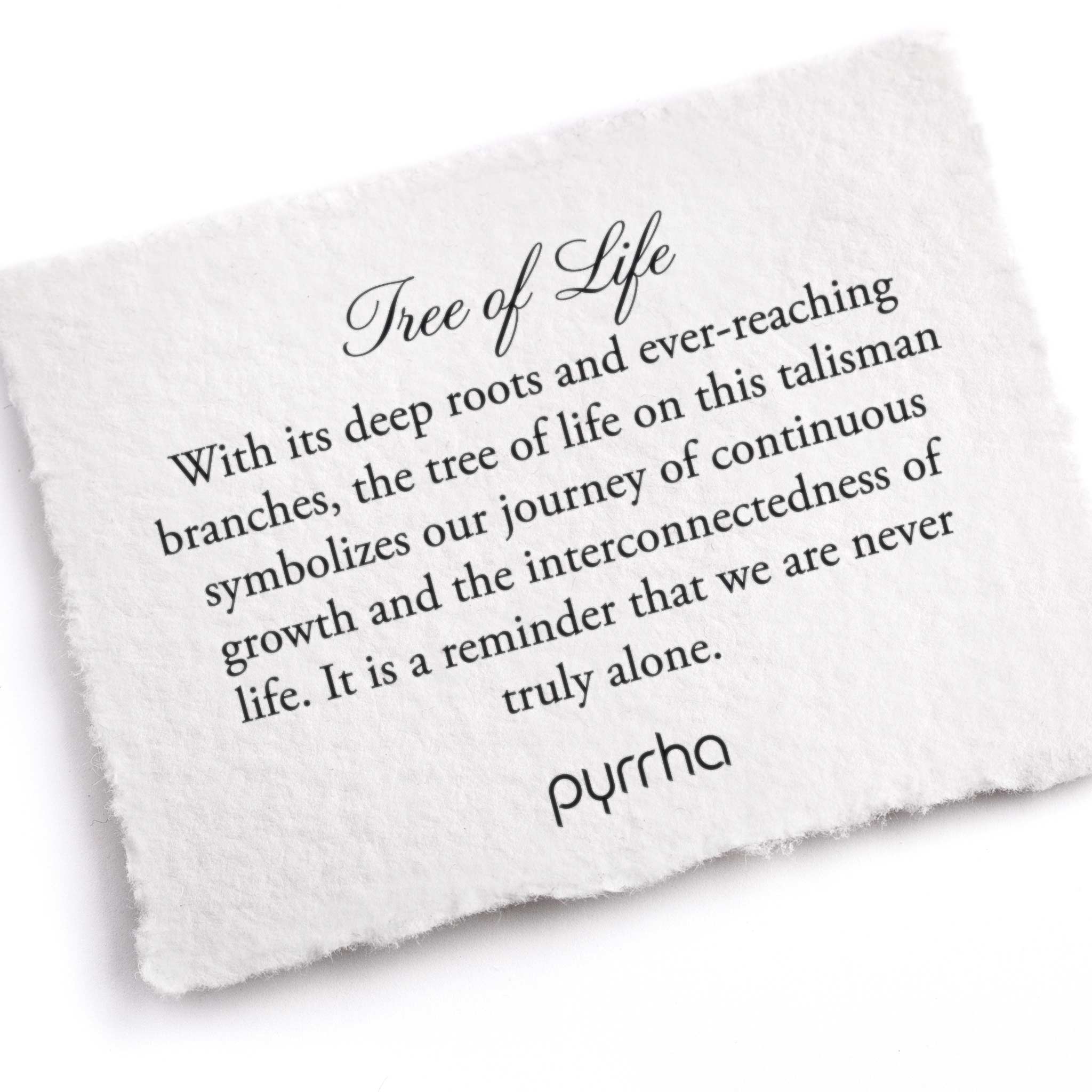 A hand-torn, letterpress printed card describing the meaning for Pyrrha's Tree of Life 14K Gold Talisman