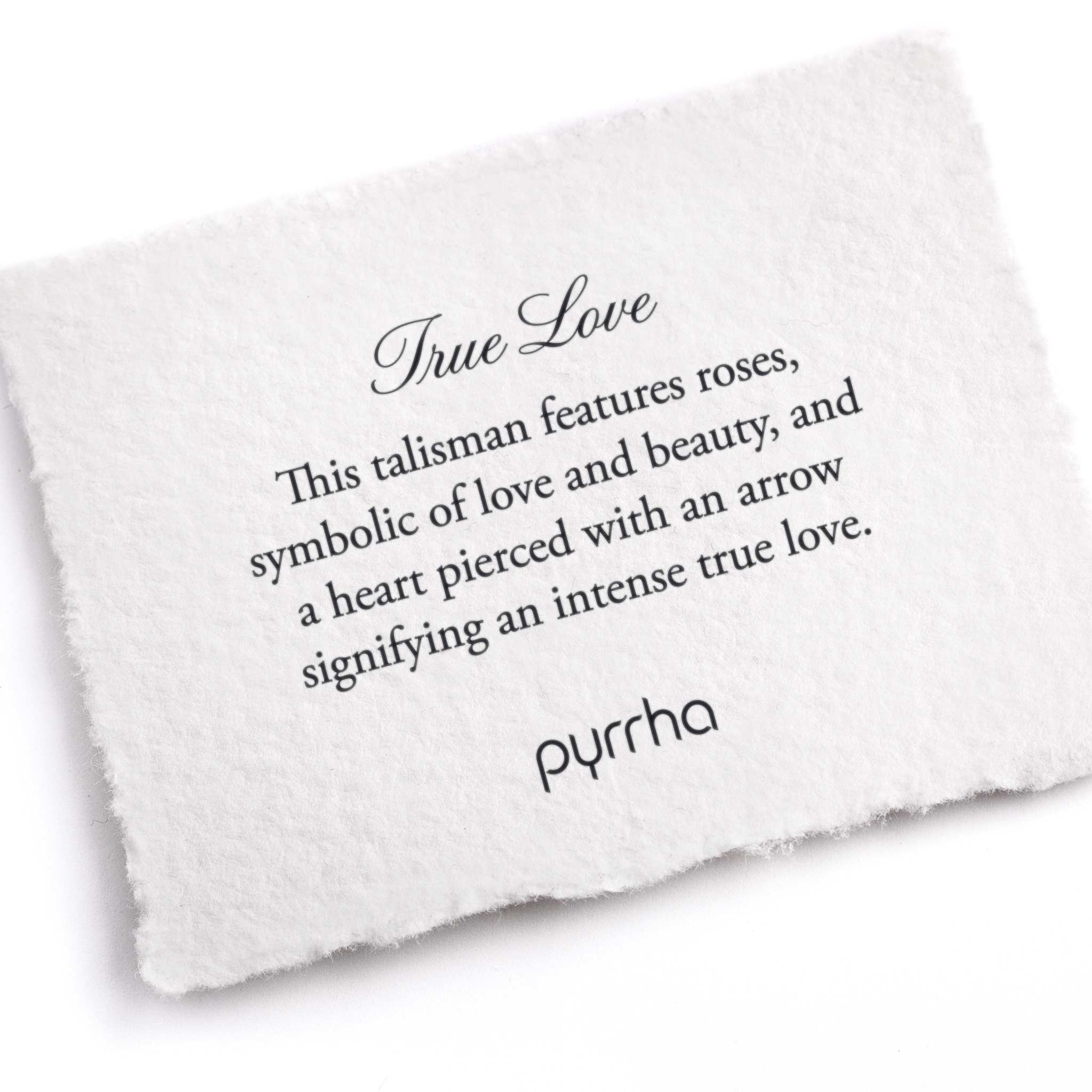 A hand-torn, letterpress printed card describing the meaning for Pyrrha's True Love Talisman