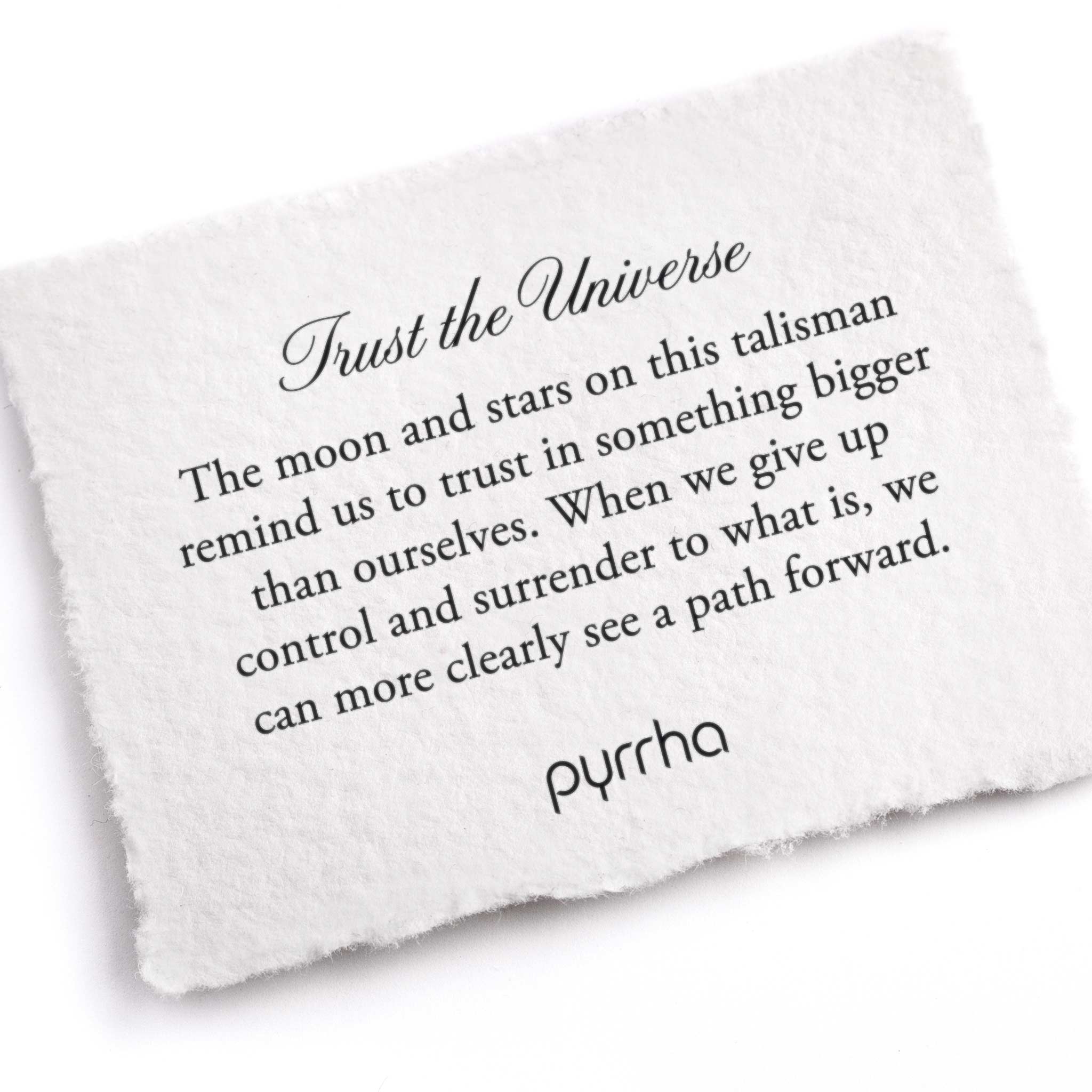 A hand-torn, letterpress printed card describing the meaning for Pyrrha's Trust the Universe Signature Talisman Necklace