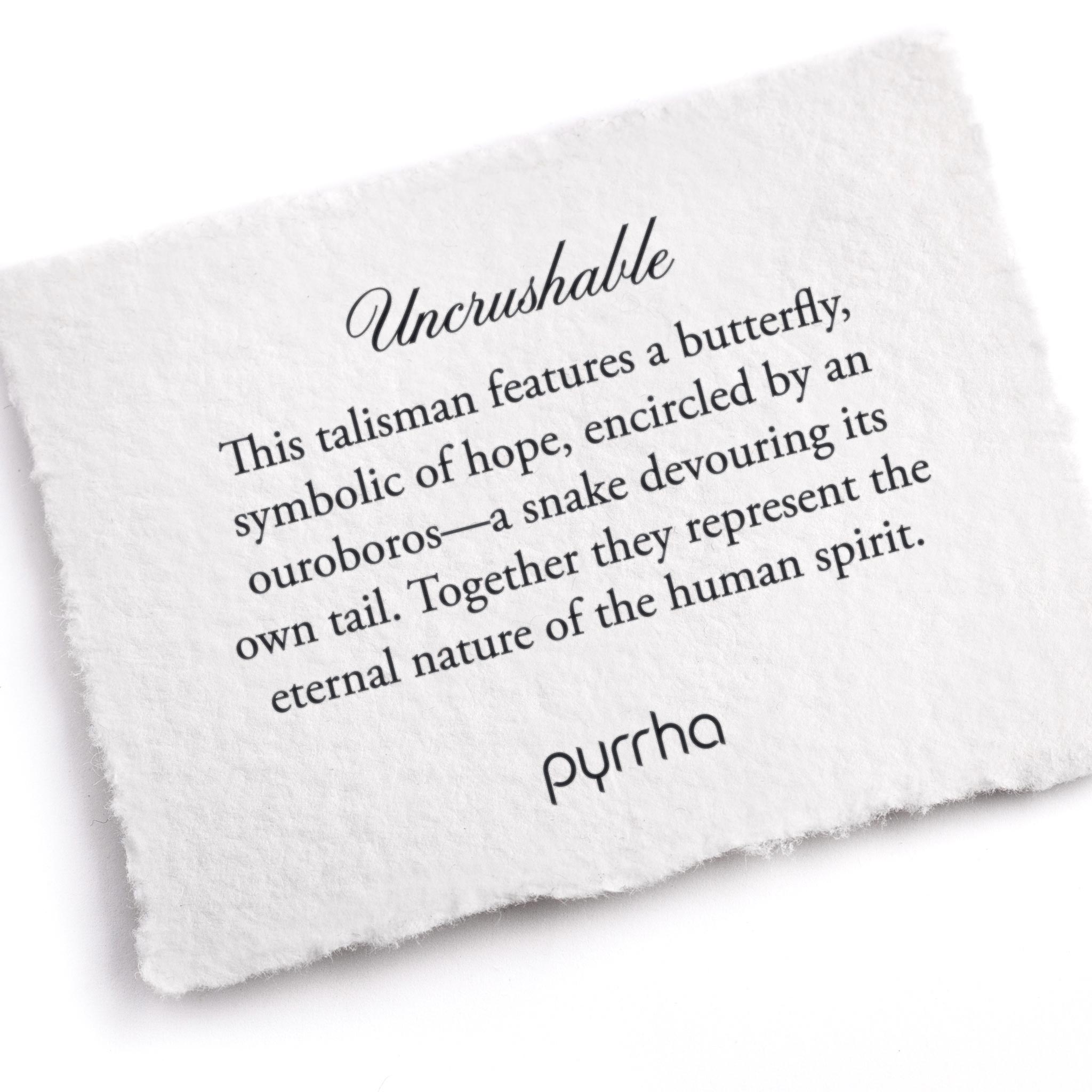 A hand-torn, letterpress printed card describing the meaning for Pyrrha's Uncrushable Talisman